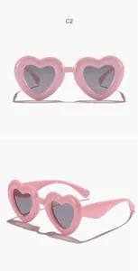 Detail views of pink heart-shaped children's sunglasses with retro UV protection lenses
