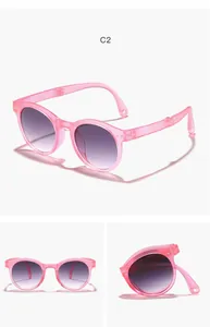 Makrodetail und Klappmechanismus der rosa runden Kinder-Sonnenbrille mit lila Gläsern