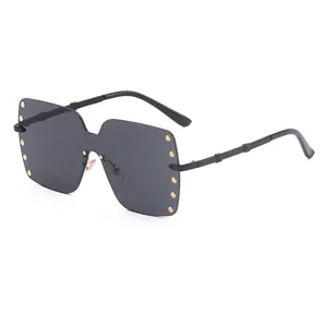 Premium oversized rimless sunglasses featuring gold rivet accents on dark black lenses