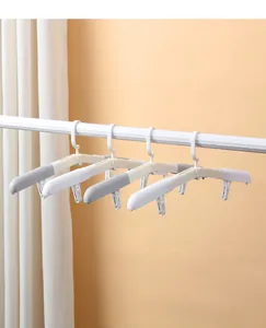 Portable folding travel hangers with clips shown hanging on a clothes rail in a row