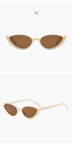 Detailed view of vintage beige cat-eye semi-rimless sunglasses with brown lenses.