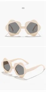 Detail view of cream flower-shaped children's sunglasses from front and side angles