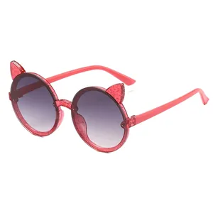 Cute children's cat-ear sunglasses with pink glitter frames and round gradient lenses.