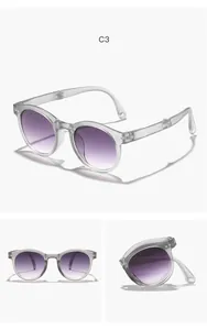 Faltbare runde Kindersonnenbrille mit lila Verlaufsgläsern und klarem grauem Rahmen
