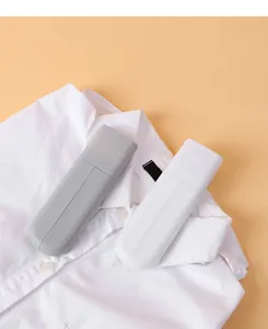 Close-up view showing the compact closed state of grey and white portable travel hangers.