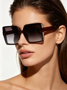 Stylish close-up of a woman wearing oversized square burgundy sunglasses with glitter details