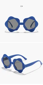 Detailed view of fashionable blue flower-shaped children's sunglasses with gray lenses.