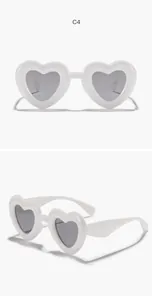 Front and side view of white heart-shaped children's sunglasses with grey lenses
