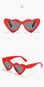 Detailed view of red heart-shaped children's sunglasses with dark lenses for eye protection