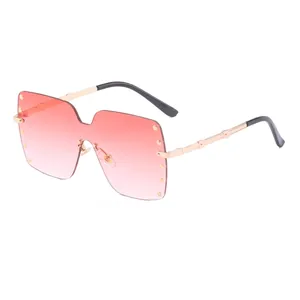 Oversized rimless sunglasses for women with pink gradient lenses and gold rivet accents