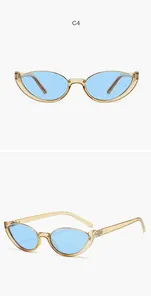 Detail view of retro cat-eye sunglasses with transparent yellow frame and blue lenses