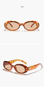 Detailed view of vintage oval sunglasses with tortoiseshell frame and brown lenses.