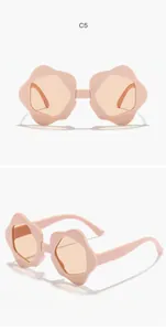 Close-up detail of stylish kids flower-shaped sunglasses in soft light pink finish