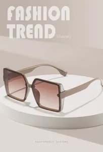Close-up of stylish oversized square sunglasses with glitter accents on frame