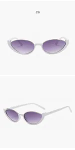 Macro detail of white cat-eye semi-rimless sunglasses featuring purple gradient lenses