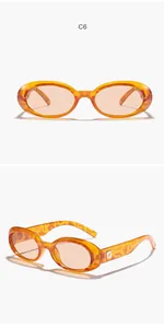 Detailed view of retro oval sunglasses featuring amber tortoiseshell frames and light lenses