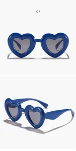 Detailed views of blue heart-shaped sunglasses for children with dark UV protection lenses.