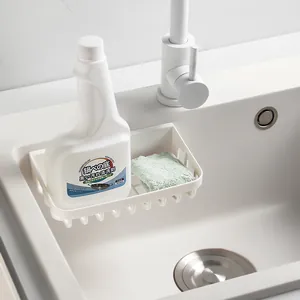 White wall-mounted drainage storage rack for kitchen sink with sponge holder.