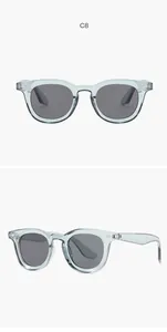Retro oval sunglasses in transparent blue finish with dark grey lenses and metal rivet details