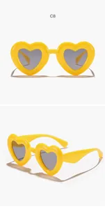 Detailed view of yellow heart-shaped children's sunglasses from multiple angles