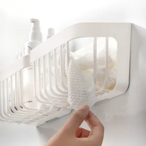 White wall-mounted hollow bathroom rack for face towel and skincare storage solutions.