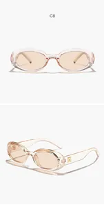 Detailed view of retro oval sunglasses with transparent champagne frames and tinted lenses