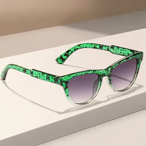Occhiali da sole quadrati alla moda con montatura verde fantasia e lenti viola sfumate