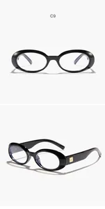 Detail views of vintage black oval sunglasses with retro frames and gold-tone logo