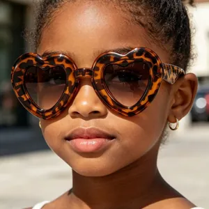 Stylish leopard print heart-shaped sunglasses for kids with retro UV protection.