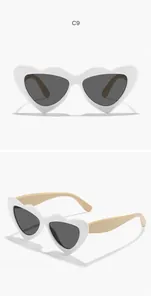 Detailed close-up showing white heart-shaped kids sunglasses with beige temples and dark lenses