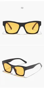Detailed view of retro square sunglasses featuring black frames and yellow lenses.