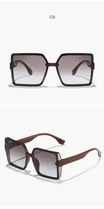 Macro view of oversized square sunglasses featuring gradient lenses and glitter accents.