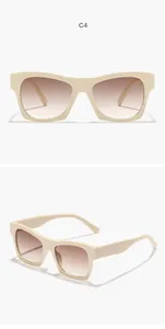 Detail view of retro square sunglasses with cream frame and gradient brown lenses