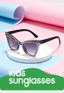 Close-up of stylish kids cat-eye sunglasses with glitter frame and gradient lenses.