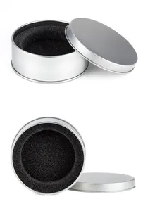 Detail view of a premium circular aluminum jewelry box featuring a black foam insert
