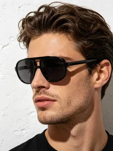 Close-up shot of stylish black double-bridge aviator sunglasses worn by a male model