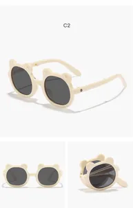 Multiple views of foldable cream children's sunglasses featuring cute bear-ear frames