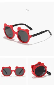 Red foldable cartoon bear-ear sunglasses for kids with round black lenses and portable design.