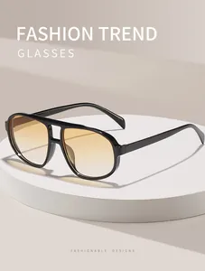 Detailed view of retro aviator sunglasses with black frame and orange gradient lenses.
