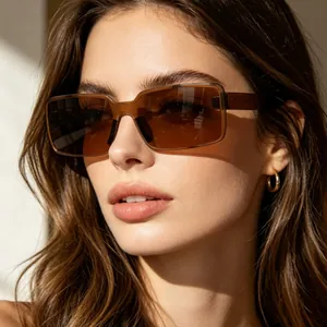 Detailed view of a woman wearing retro rectangular brown sunglasses in natural bright sunlight