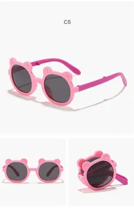 Detailed view of foldable pink bear-shaped cartoon sunglasses for children's use.