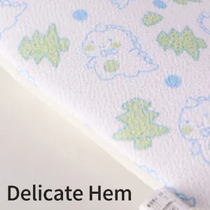 Close-up of cartoon dinosaur pattern on soft exfoliating bath scrubber