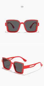 Close-up view of children's red square sunglasses featuring shiny silver glitter trim details