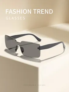 Detailed view of vintage grey rectangular sunglasses on a minimalist cream background