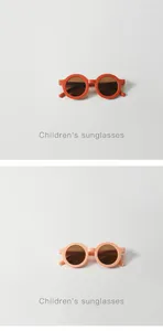 Close-up detail of round children's sunglasses in orange and peach colors for UV protection
