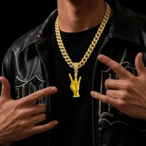 Detalle de primer plano de collar hip-hop dorado con colgante de gesto de 3 dedos