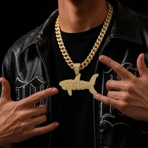 Detailed view of gold-plated iced out shark pendant necklace for men hip hop style.
