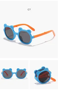 Detailed view of blue and orange foldable cartoon bear sunglasses for kids and toddlers.