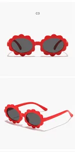 Front and angle detail shots of red flower-shaped frame sunglasses for children