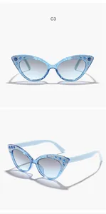 Close-up view of stylish blue glitter cat-eye sunglasses with sparkling rhinestone details